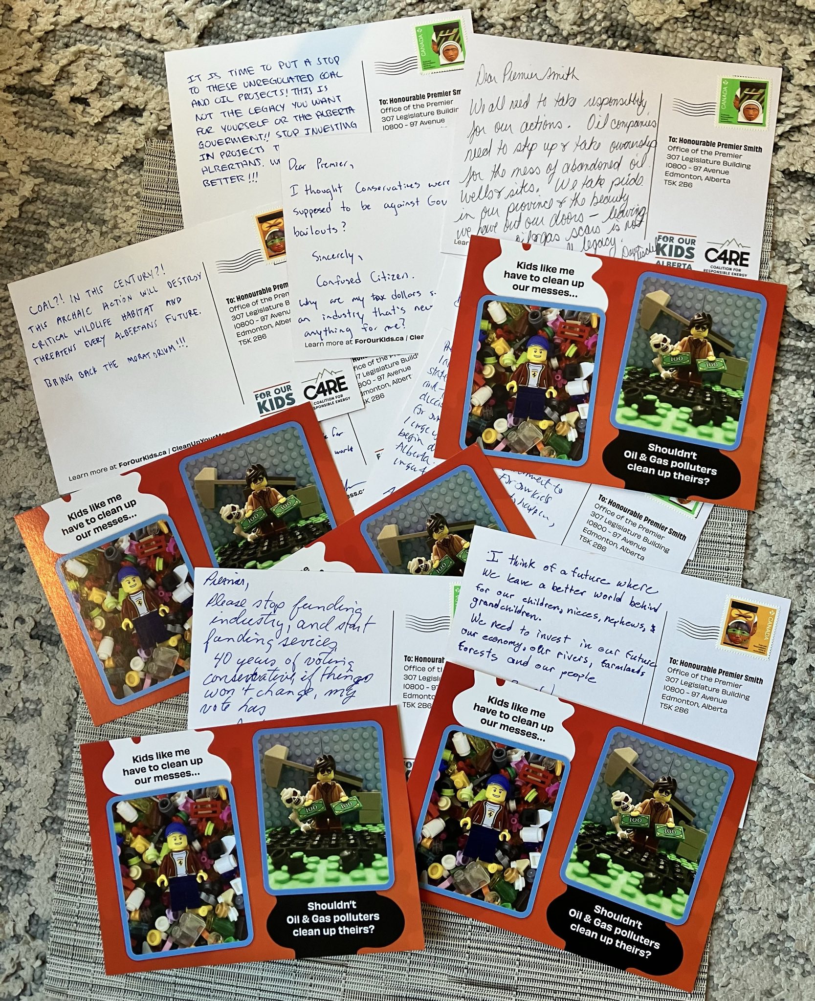 Campaign postcards with handwritten messages from attendees about oil well cleanup and coal mining